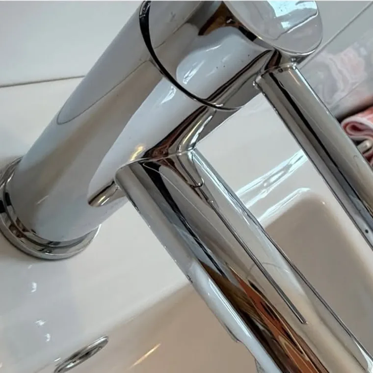 The same bath tap after cleaning, polished to a mirror finish