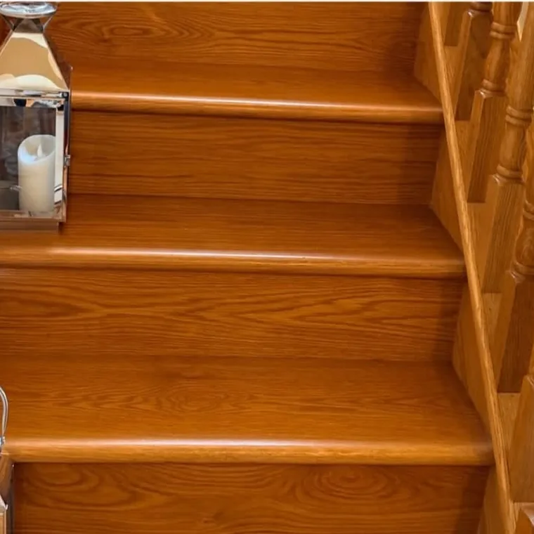 The same staircase after cleaning, restored to a deep shine