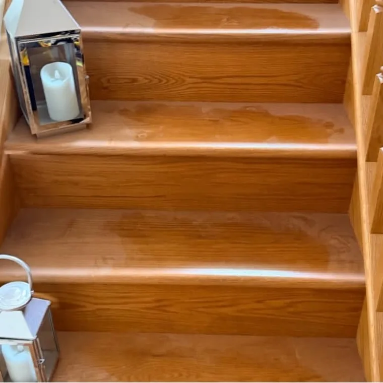 Wooden staircase before cleaning, dull and marked