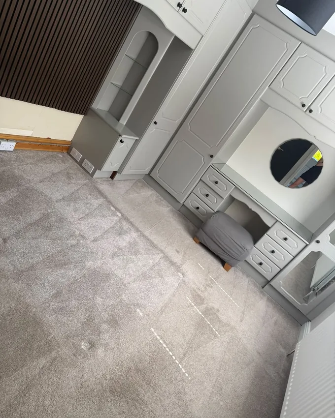 Bedroom with freshly cleaned grey carpet showing clean extraction lines